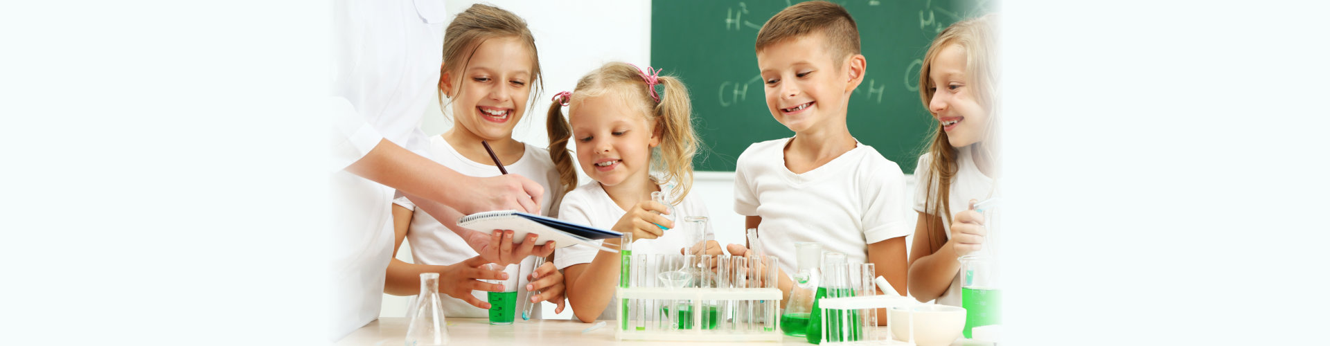 Cute pupils with teacher doing biochemistry research in chemistry class